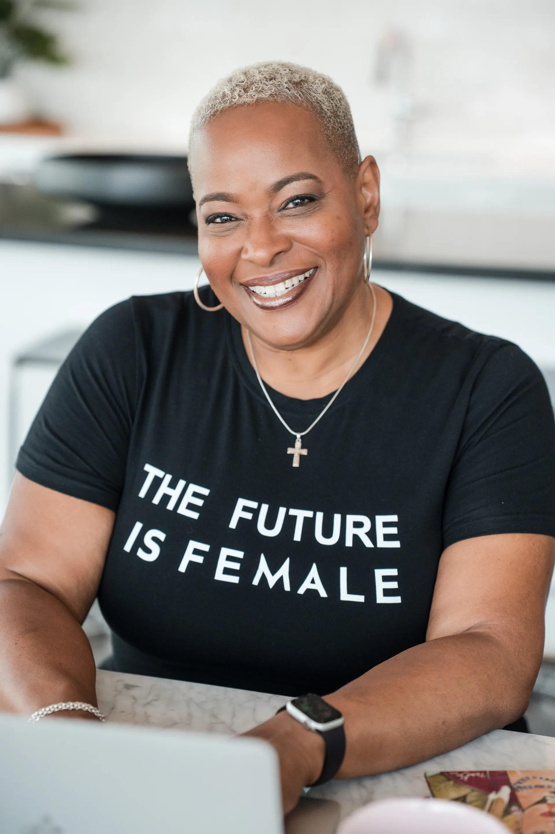 Chef Lisa Brooks smiling in her kitchen wearing a Future is Female tee
