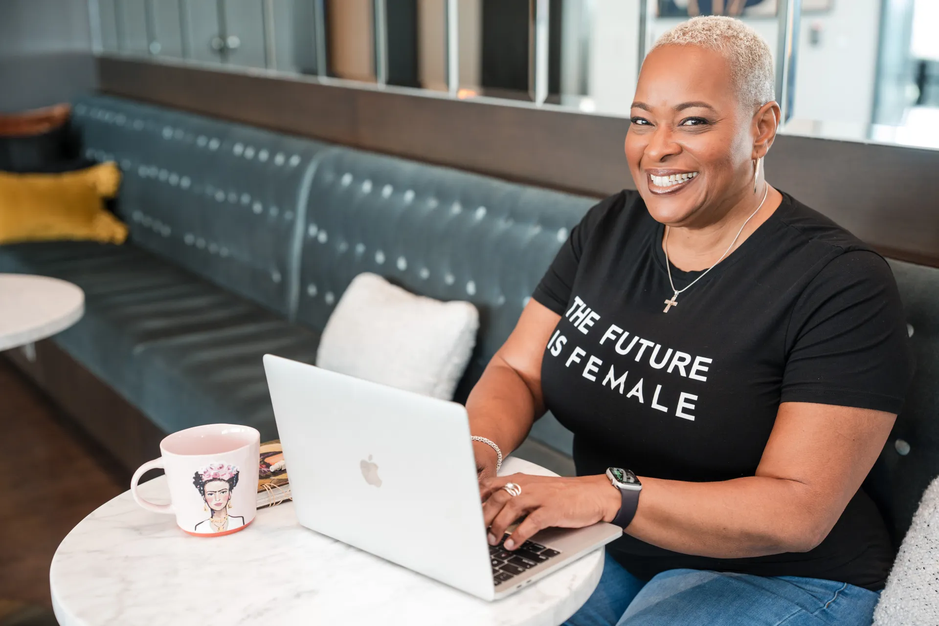 Chef Lisa Brooks at her laptop in a lounge setting