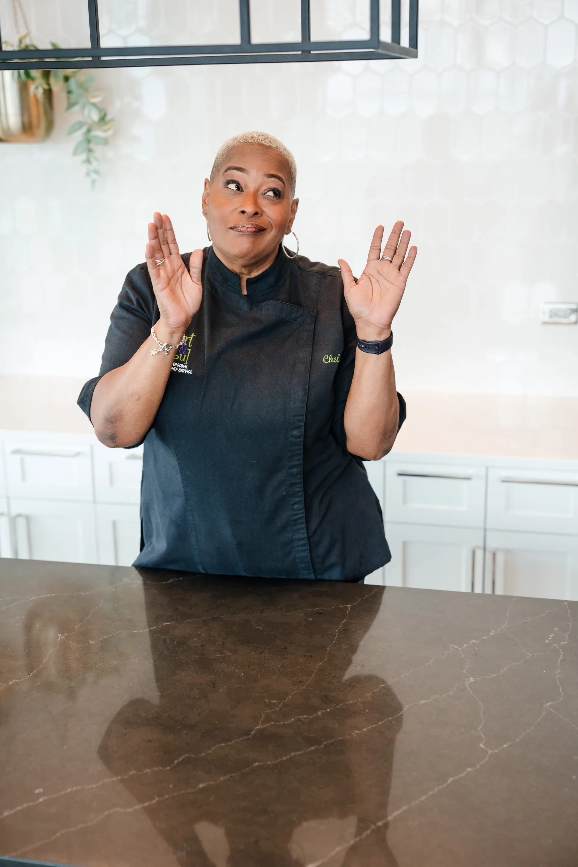 Chef Lisa Brooks in her chef coat behind the kitchen counter