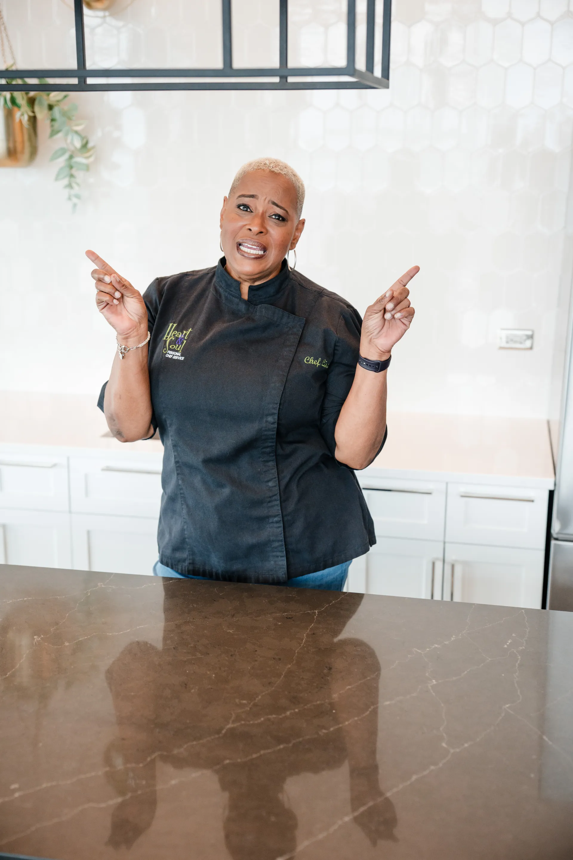 Chef Lisa Brooks pointing up with confidence